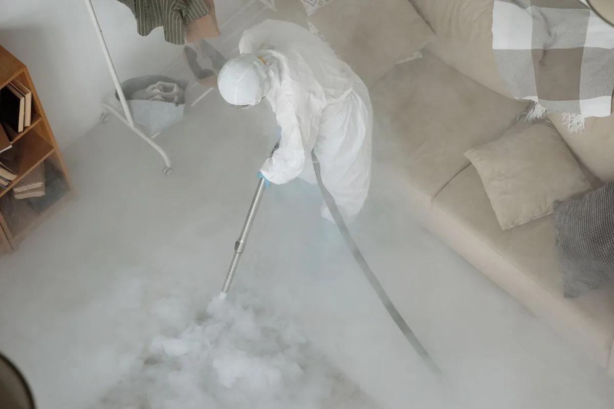 Biohazard cleanup technician in protective equipment, Inman, KS